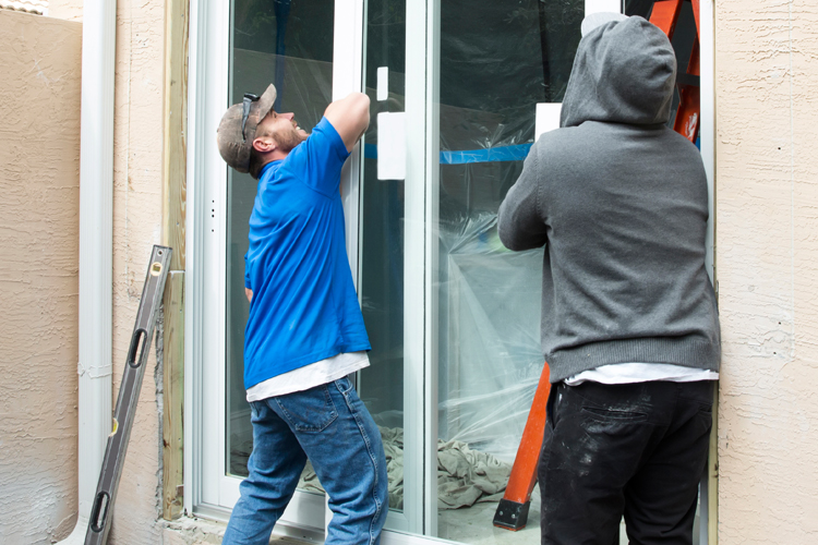 subcontracted-workers-install-sliding-glass-door-for-remodel-project